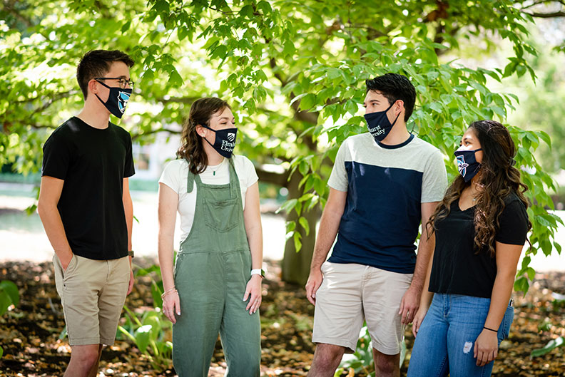 4名埃尔姆beplay体育飞翔下载赫斯特大学的学生(2男2女)戴着印有学校标志的口罩交谈。